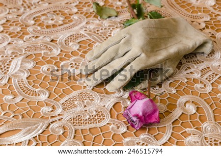 glove with a rose on an elegant table cloth