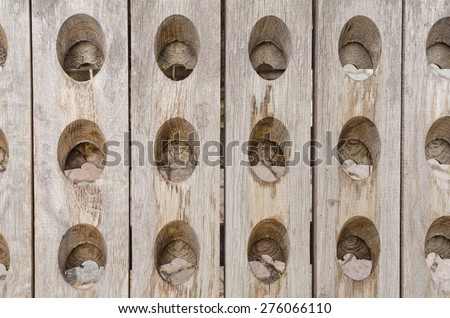 background of wooden boards assembled together with oval shaped holes building a regular pattern
