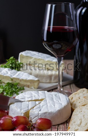 various cheese with red wine, grapes and bread
