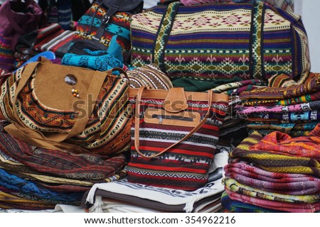 Leather trimmed purses and bags made from bright colored geometric pattern fabric for sale in the Otavalo Market