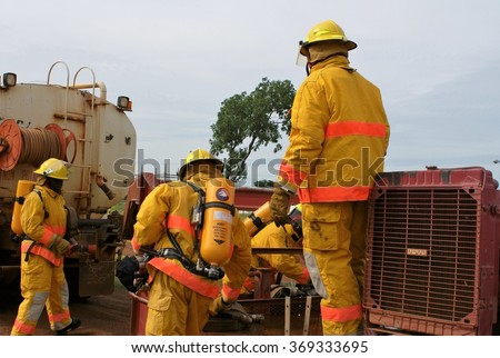 DOBA, CHAD - SEPTEMBER 1, 2013: Firefighters connecting a fire pump to a tanker during a training exercise