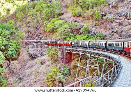 Train going over a bridge over a gorge on the Kuranda Scenic Railway in Barron Gorge National Park, Australia