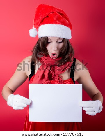 Christmas girl in santa hat holding banner. Isolated.
