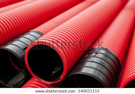 Red plastic tubes in the warehouse.