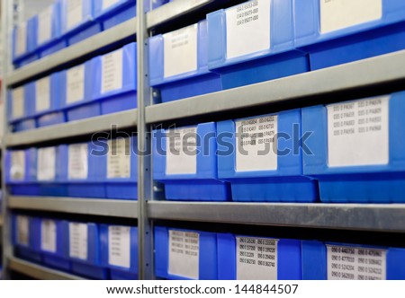 Blue plastic boxes on the metal shelf.