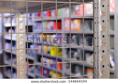 Empty metal shelf closeup in the car spare part\'s shop. Focus on foreground.
