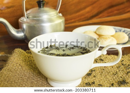 Tea cups with a tea kettle on a table
