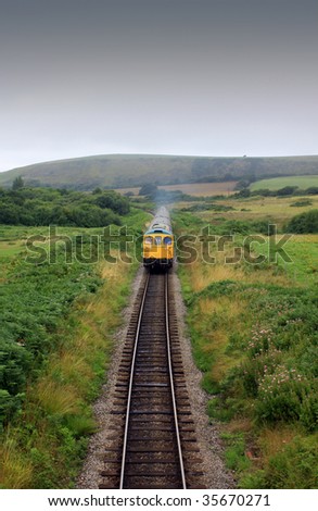 The front end of a diesel train on the Swanage railway in Dorset UK. A front on view of the train on the track shot from a small bridge between Corfe Castle and Swange.
