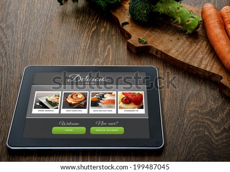 Cooking recipe on tablet pc with vegetables on background