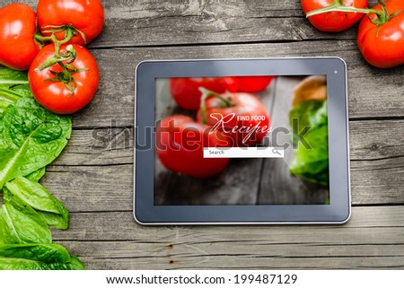 Cooking recipes on tablet pc with vegetables on background.