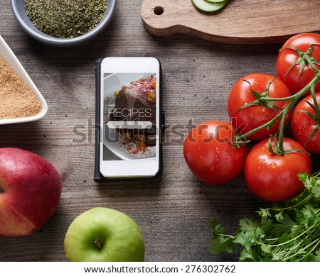 Food recipes smart phone on rustic wooden table