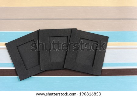 Blank photographs frames over colorful stiped background