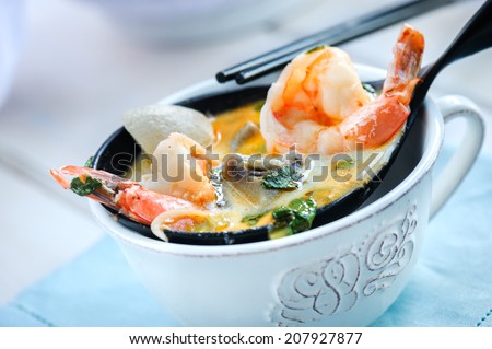 Cooked shrimps on a decorative spoon with fresh herbs