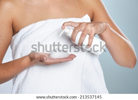Female hands using cosmetic liquid soap or hand sanitizer close up