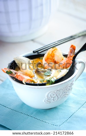 Cooked shrimps on a decorative spoon with fresh herbs