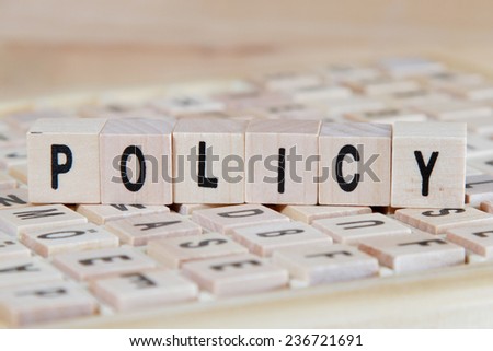 policy word background on wood blocks