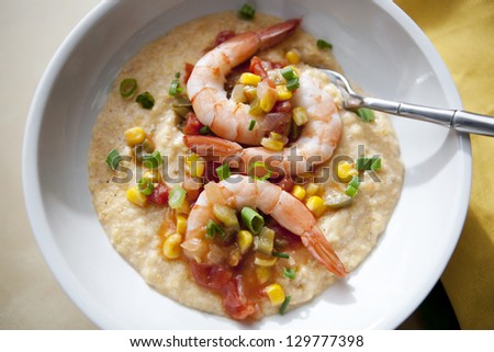 simple meal of shrimp and grits with sauteed vegetables