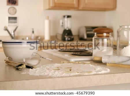 A messy kitchen in the midst of baking cookies