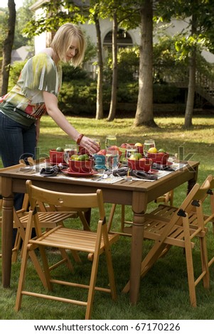 Woman Setting Table for Outdoor Dinner Party