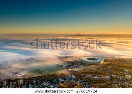 Shortly after sunrise in Cape Town, the fog arrives from the sea and envelops the lower part of the city- including the stadium.