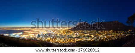 Shortly before dawn, the beautiful blue-hour is captured in Cape Town. This panorama features Downton and the Table Mountain National Park