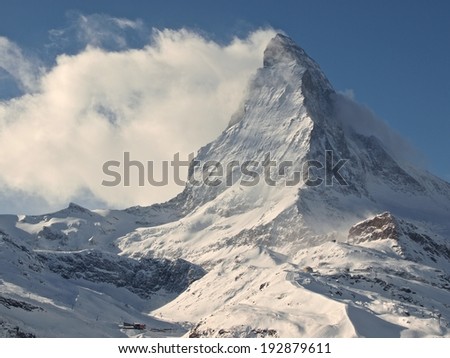 Panorama of Swiss Alps with Matterhorn Peak and Glacier, Sun and Clouds