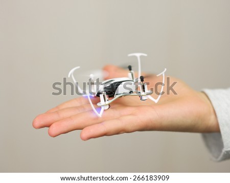 Child holding a Remote Controlled Mini Quadcopter Drone