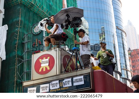 Hong Kong - October 5 2014: Occupy Central protest movement - TV reporter shoot people demonstrations in Mong Kok Station cover.