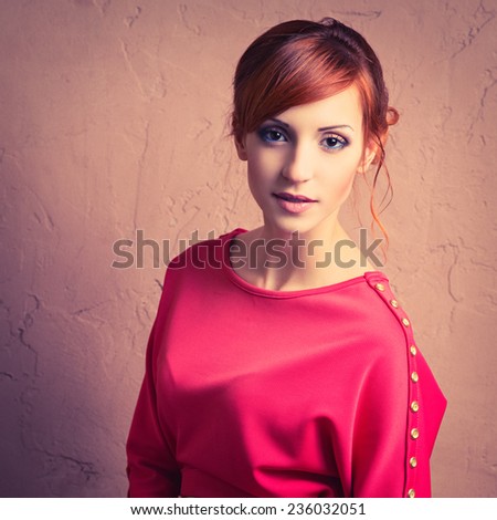 Beautiful young fashionable woman posing in red dress. Looking at camera. Vogue style. Photo with instagram style filters