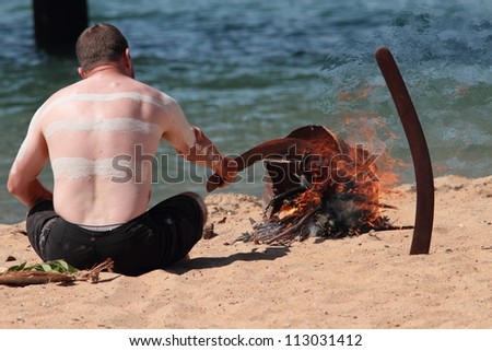 BRISBANE, AUSTRALIA - SEPTEMBER 16 : Unidentified aboriginal man conducting fire ceremony as part of the Redcliffe First Settlement Festival on September 16, 2012 in Brisbane, Australia