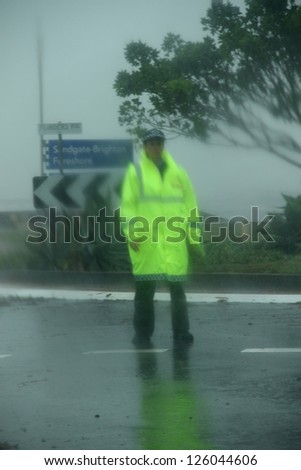 BRISBANE, AUSTRALIA - JANUARY 27 : Unidentified police woman guards flooded road during ex tropical cyclone Oswald on January 27, 2013 in Brisbane, Australia