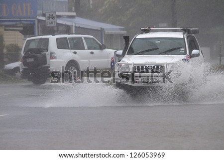 BRISBANE, AUSTRALIA - JANUARY 27 : Four wheel drives crossing flooded roads during tropical cyclone Oswald on January 27, 2013 in Brisbane, Australia