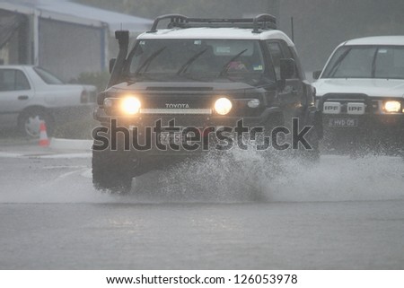 BRISBANE, AUSTRALIA - JANUARY 27 : Four wheel drives crossing flooded roads during tropical cyclone Oswald on January 27, 2013 in Brisbane, Australia
