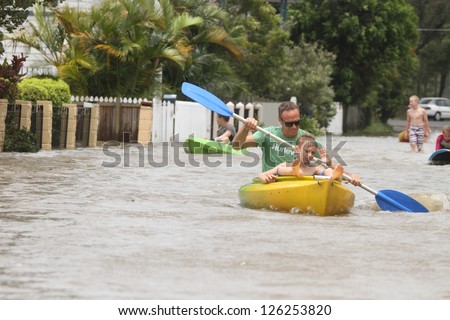 BRISBANE, AUSTRALIA - JANUARY 28 : Unidentified residents taking canoe rides in flooded street from ex tropical cyclone Oswald on January 28, 2013 in Brisbane, Australia
