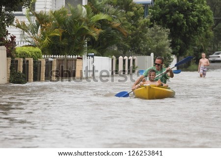 BRISBANE, AUSTRALIA - JANUARY 28 : Unidentified residents taking canoe rides in flooded street from ex tropical cyclone Oswald on January 28, 2013 in Brisbane, Australia