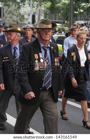 BRISBANE, AUSTRALIA - APRIL 25 : Veterans march along the route during Anzac day commemorations  April 25, 2013 in Brisbane, Australia