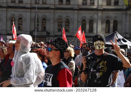 BRISBANE, AUSTRALIA - JULY 06 : Unidentified protester wearing anonymous mask at Bust The Budget anti liberal governement Rally July 06, 2014 in Brisbane, Australia