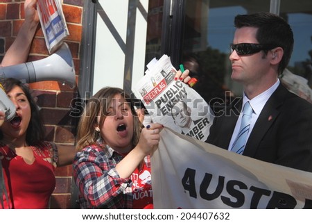 BRISBANE, AUSTRALIA - JULY 12 : Unidentified anti government protesters confronted by federal police outside Liberal National Party national conerfence July 12, 2014 in Brisbane, Australia