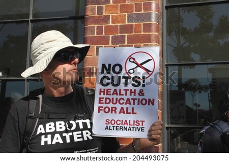 BRISBANE, AUSTRALIA - JULY 12 : Unidentified protester with anti government signs outside Liberal National Party national conference July 12, 2014 in Brisbane, Australia