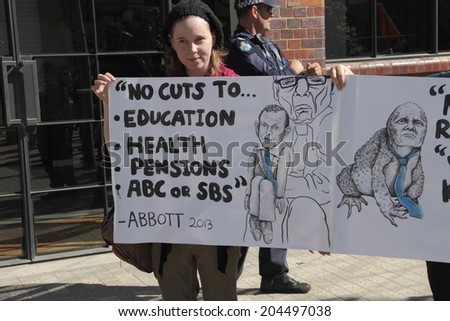 BRISBANE, AUSTRALIA - JULY 12 : Unidentified protester with broken LNP election promises signs outside Liberal National Party national conference July 12, 2014 in Brisbane, Australia