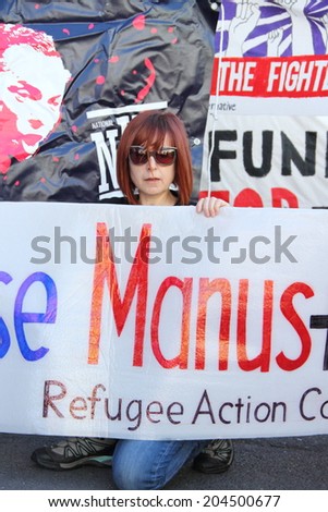 BRISBANE, AUSTRALIA - JULY 12 : Unidentified protester with anti government refugee policy sign outside Liberal National Party national conference July 12, 2014 in Brisbane, Australia
