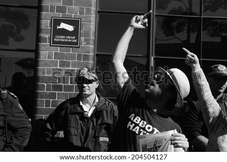 BRISBANE, AUSTRALIA - JULY 12 : Unidentified anti government protester giving primeminister the finger outside Liberal National Party national conference July 12, 2014 in Brisbane, Australia