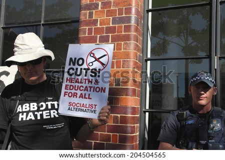 BRISBANE, AUSTRALIA - JULY 12 : Unidentified protesters outside police cordon Liberal National Party national conference July 12, 2014 in Brisbane, Australia