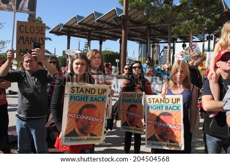 BRISBANE, AUSTRALIA - JULY 12 : Unidentified protesters with anti government signs outside Liberal National Party national conference July 12, 2014 in Brisbane, Australia