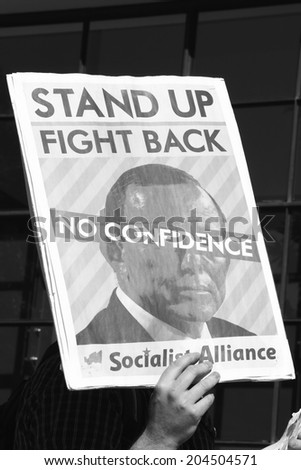 BRISBANE, AUSTRALIA - JULY 12 : Unidentified protester with anti Abbott sign outside Liberal National Party national conference July 12, 2014 in Brisbane, Australia