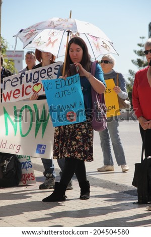 BRISBANE, AUSTRALIA - JULY 12 : Unidentified protesters with anti education and refugee policy signs outside Liberal National Party national conference July 12, 2014 in Brisbane, Australia