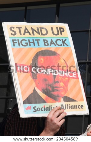 BRISBANE, AUSTRALIA - JULY 12 : Unidentified protester with anti Abbott sign outside Liberal National Party national conference July 12, 2014 in Brisbane, Australia