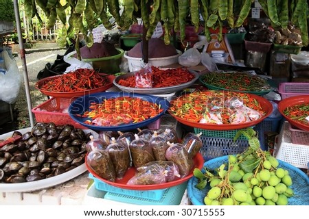 Fresh food stall in asia phuket Thailand selling chillies spices soup