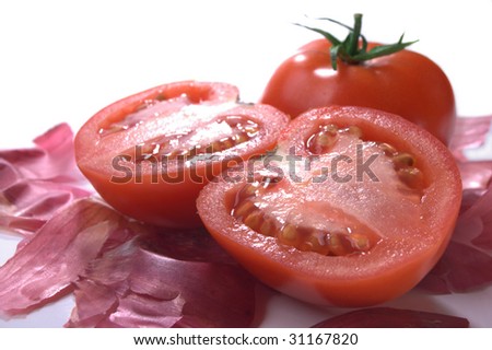 tomato half and whole on bed of red onion skins