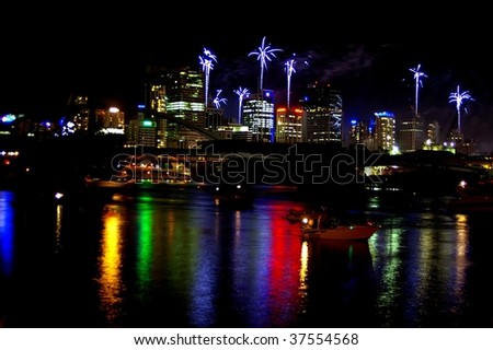 Fireworks reflected in the Brisbane water with skyscrapers during the river fire festival